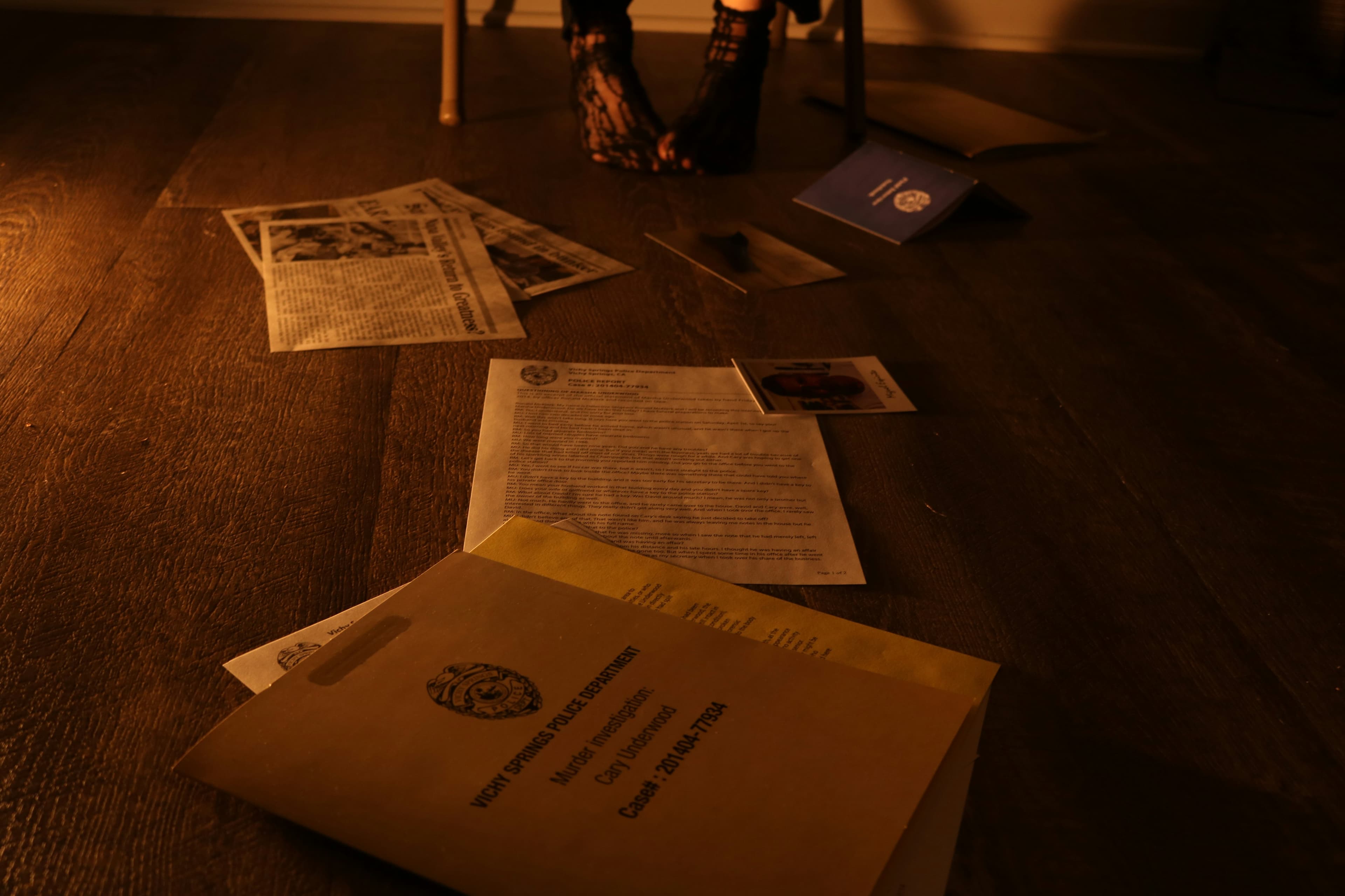 Open case files, notes, and pen on a desk—premium mystery dossier tone.